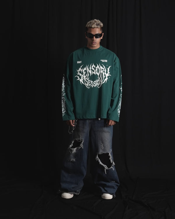 DARK GREEN oversized full-sleeve graphic T-shirt with distressed white front print and sleeve designs on a male model.