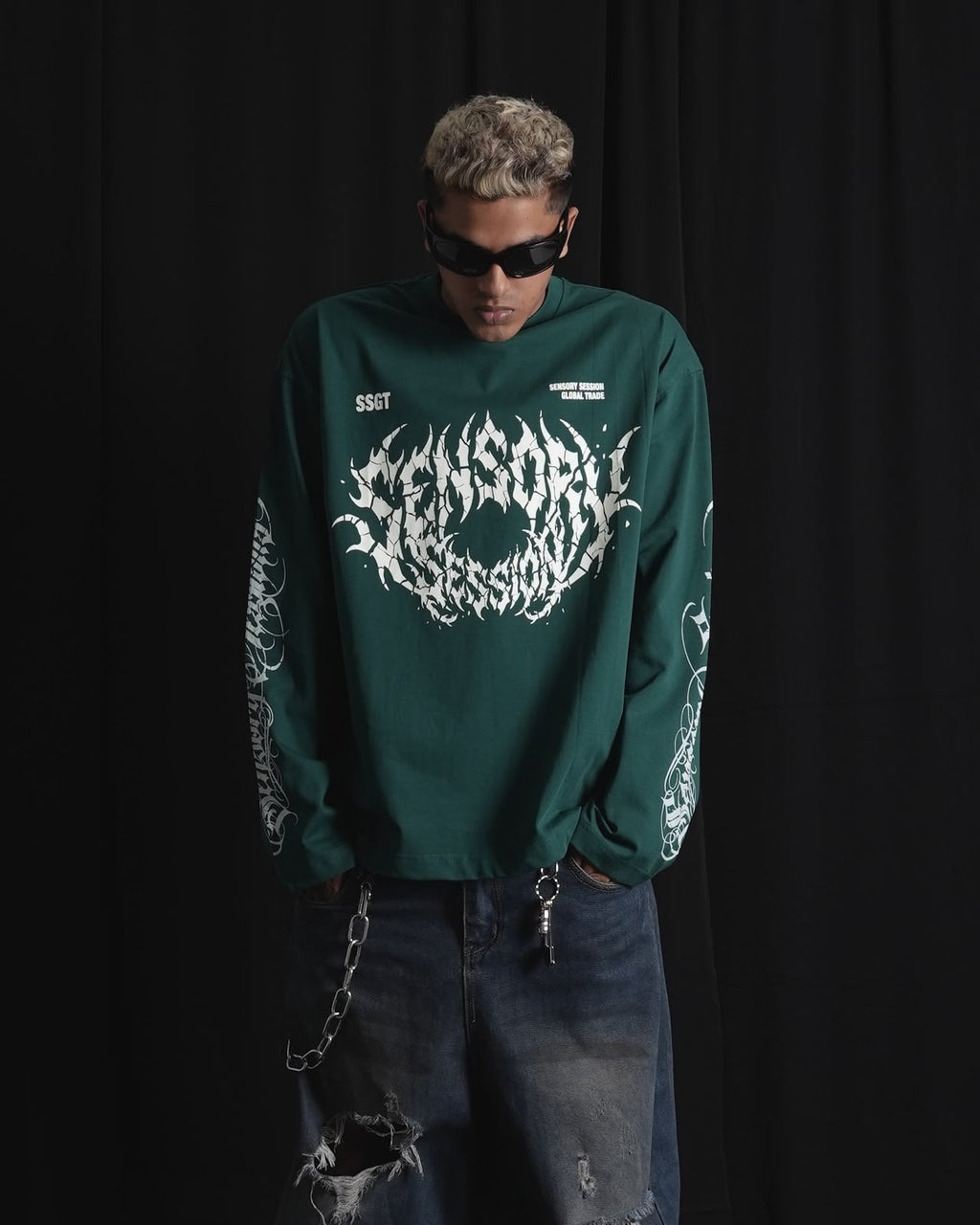 DARK GREEN oversized full-sleeve graphic T-shirt with distressed white front print and sleeve designs on a male model.
