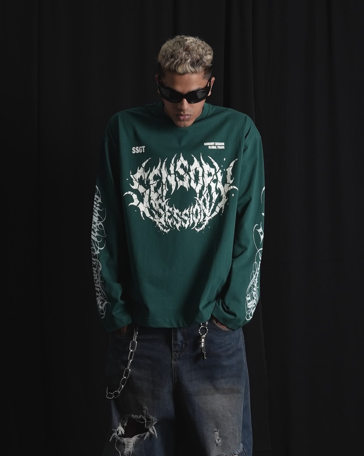DARK GREEN oversized full-sleeve graphic T-shirt with distressed white front print and sleeve designs on a male model.