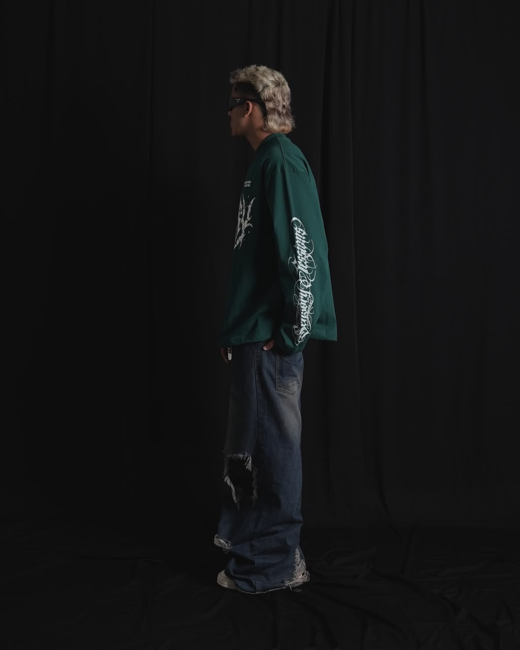 DARK GREEN oversized full-sleeve graphic T-shirt with distressed white front print and sleeve designs on a male model.