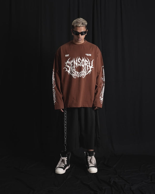 BROWN oversized full-sleeve graphic T-shirt with distressed white front print and sleeve designs on a male 