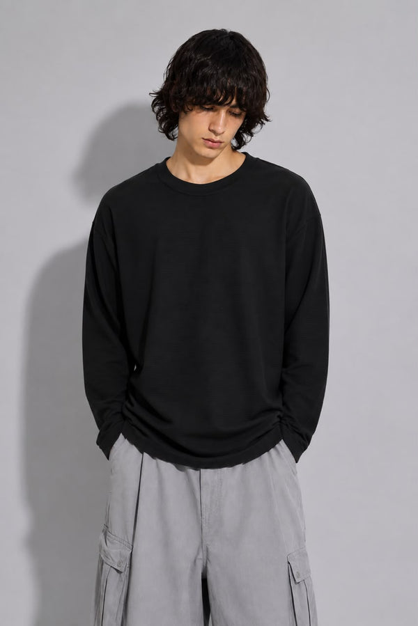 oversized long sleeve T-shirt with textured fabric, styled with light gray cargo pants.