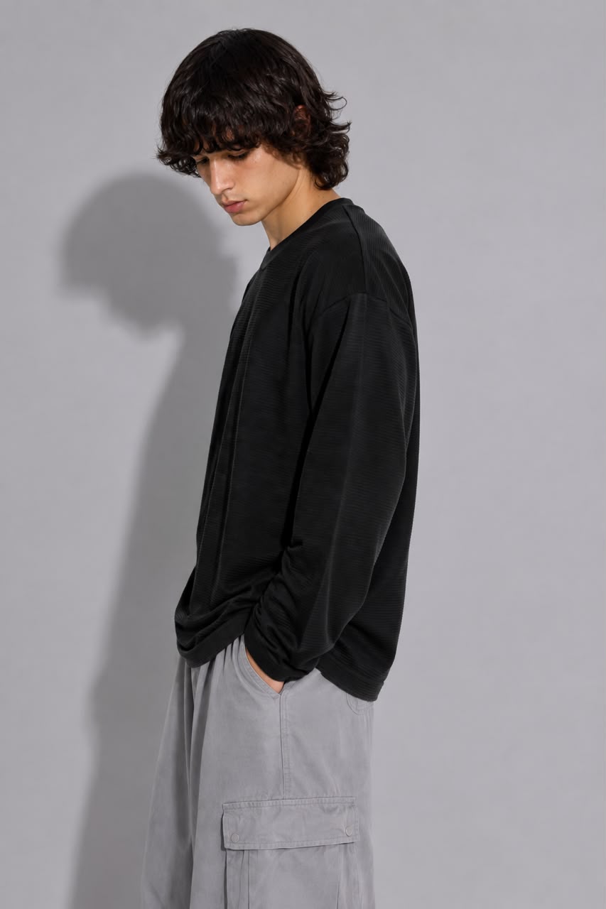 oversized long sleeve T-shirt with textured fabric, styled with light gray cargo pants.