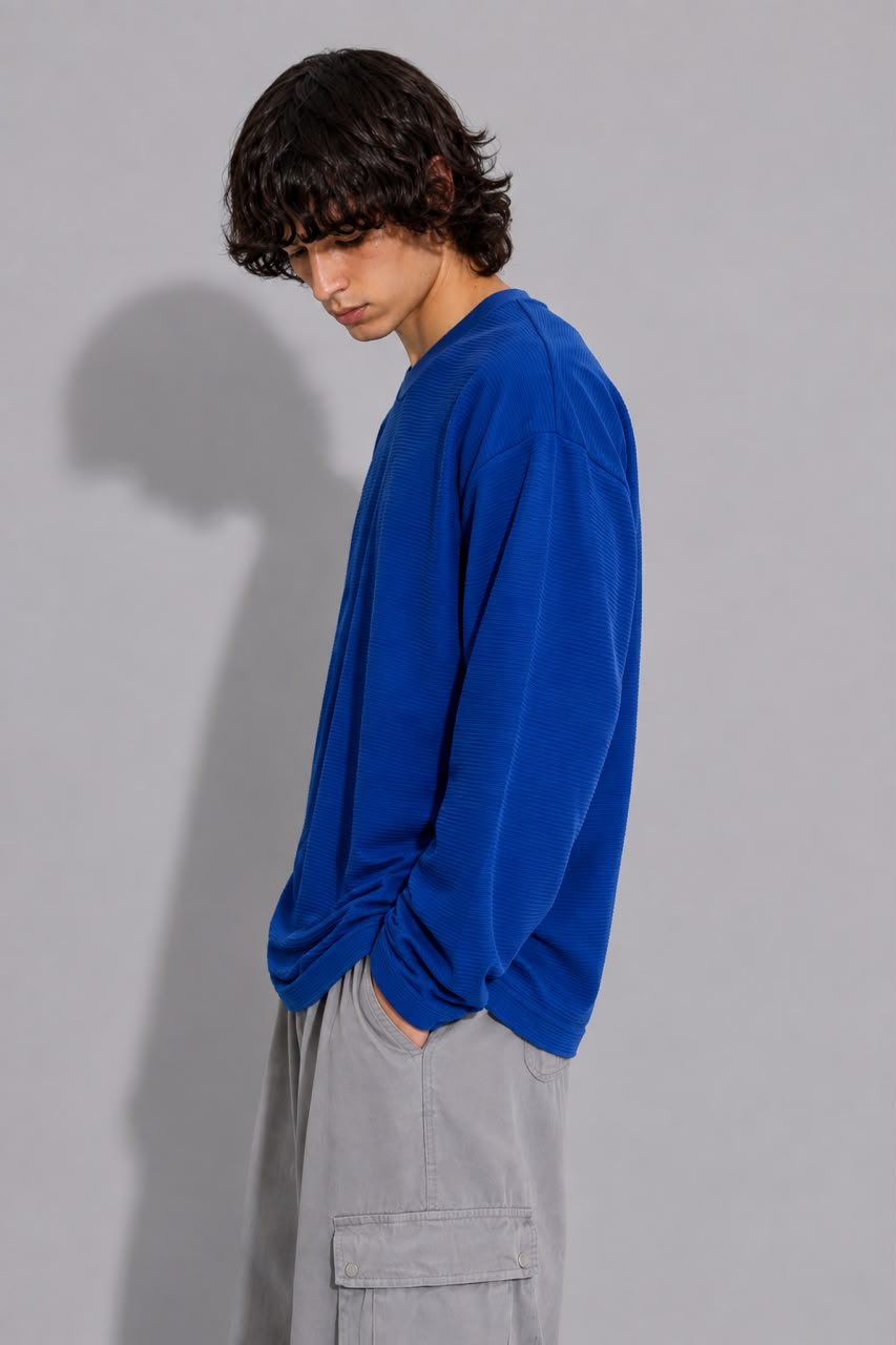 oversized long sleeve T-shirt with textured fabric, styled with light gray cargo pants.
