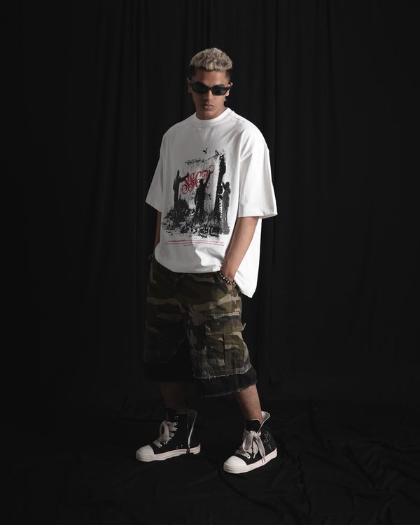 white oversized graphic T-shirt with bold white and red urban graffiti print styled on a male model.