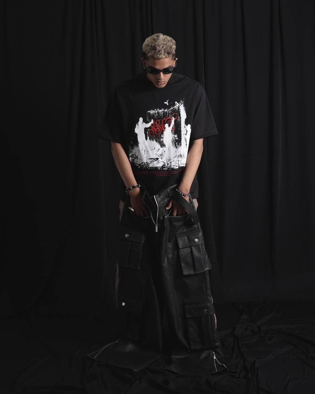 Black oversized graphic T-shirt with bold white and red urban graffiti print styled on a male model.