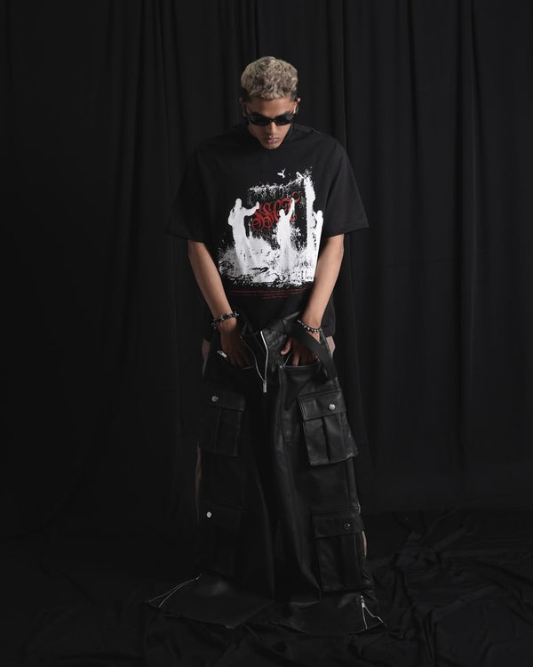Black oversized graphic T-shirt with bold white and red urban graffiti print styled on a male model.