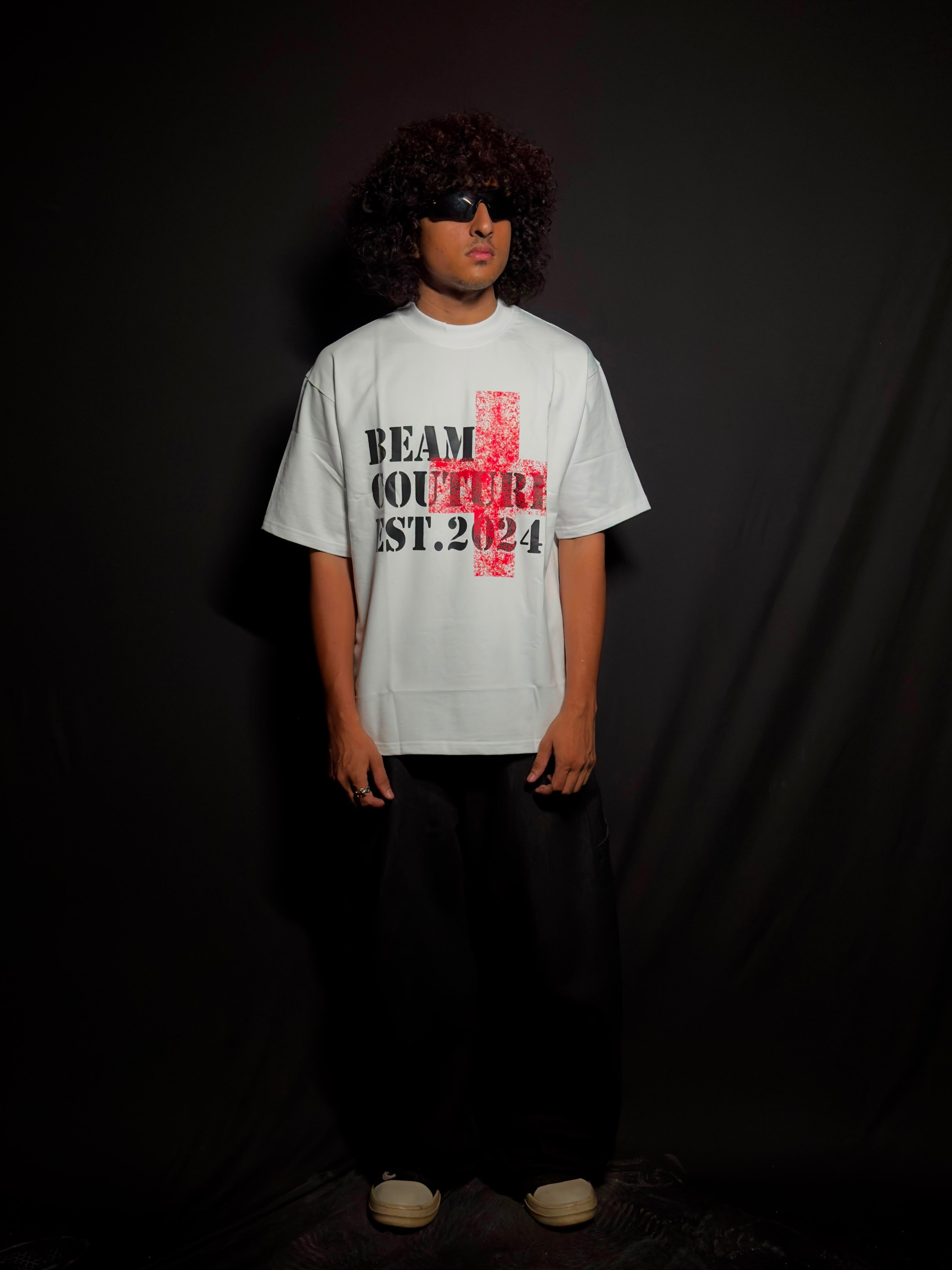 Model wearing a white oversized graphic T-shirt