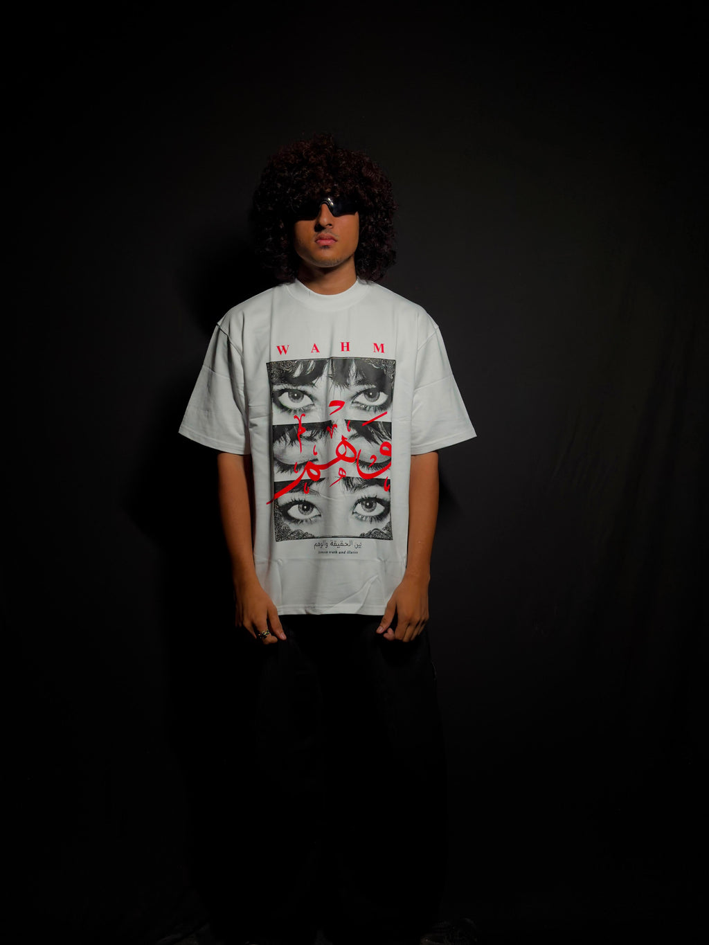 Model wearing a white oversized graphic T-shirt