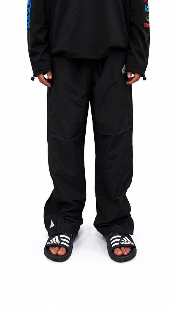 Black urban utility cargo track pants with a relaxed fit
