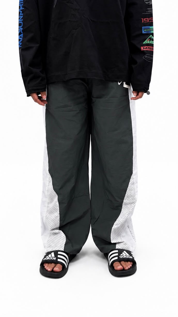 Black urban utility cargo track pants with a relaxed fit