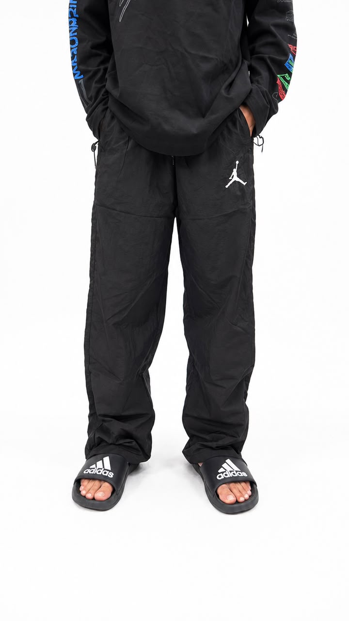 Black urban utility cargo track pants with a relaxed fit