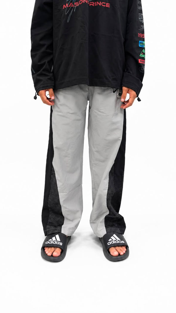 Black urban utility cargo track pants with a relaxed fit