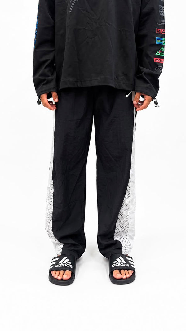 Black urban utility cargo track pants with a relaxed fit