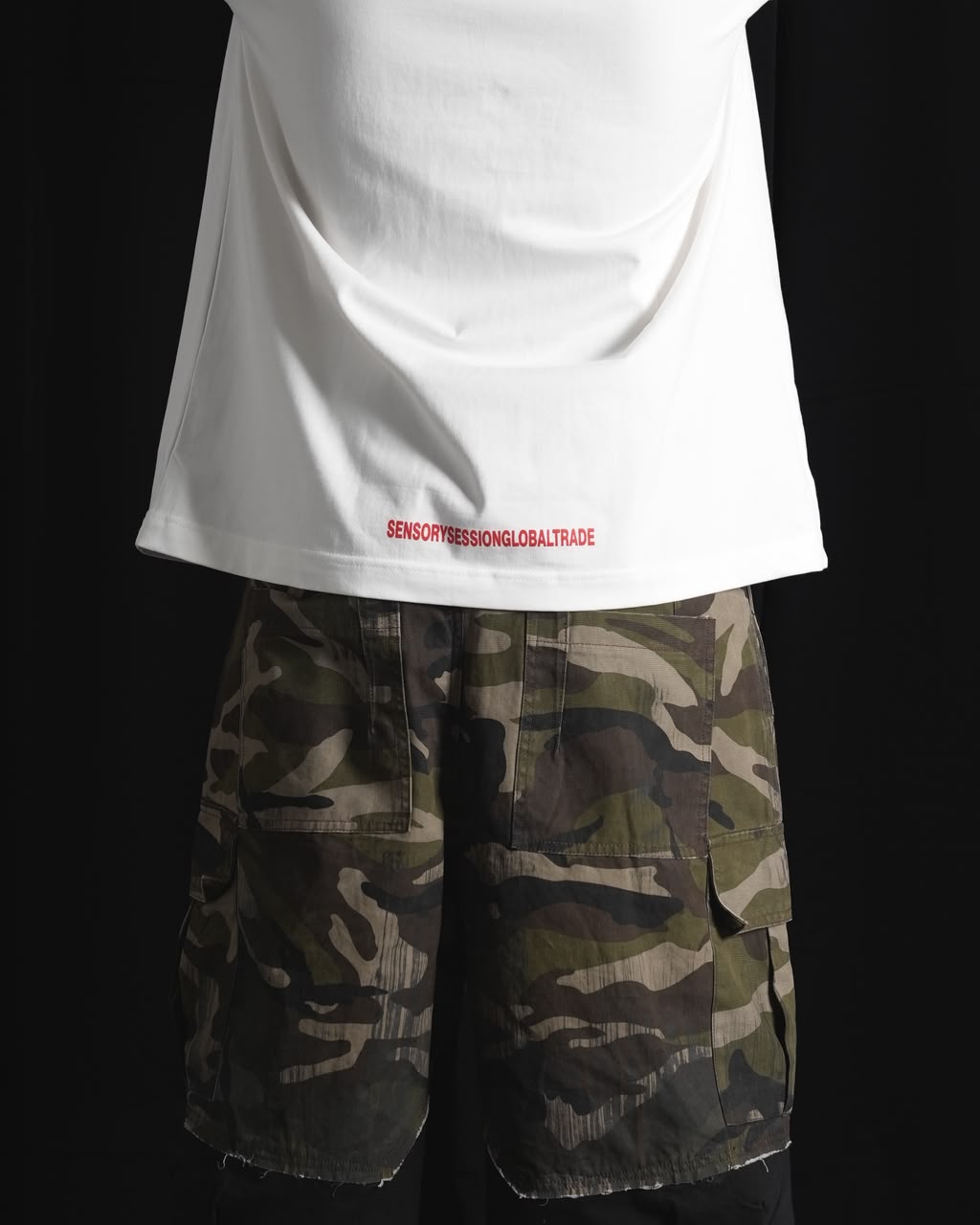 white oversized graphic T-shirt with bold white and red urban graffiti print styled on a male model.