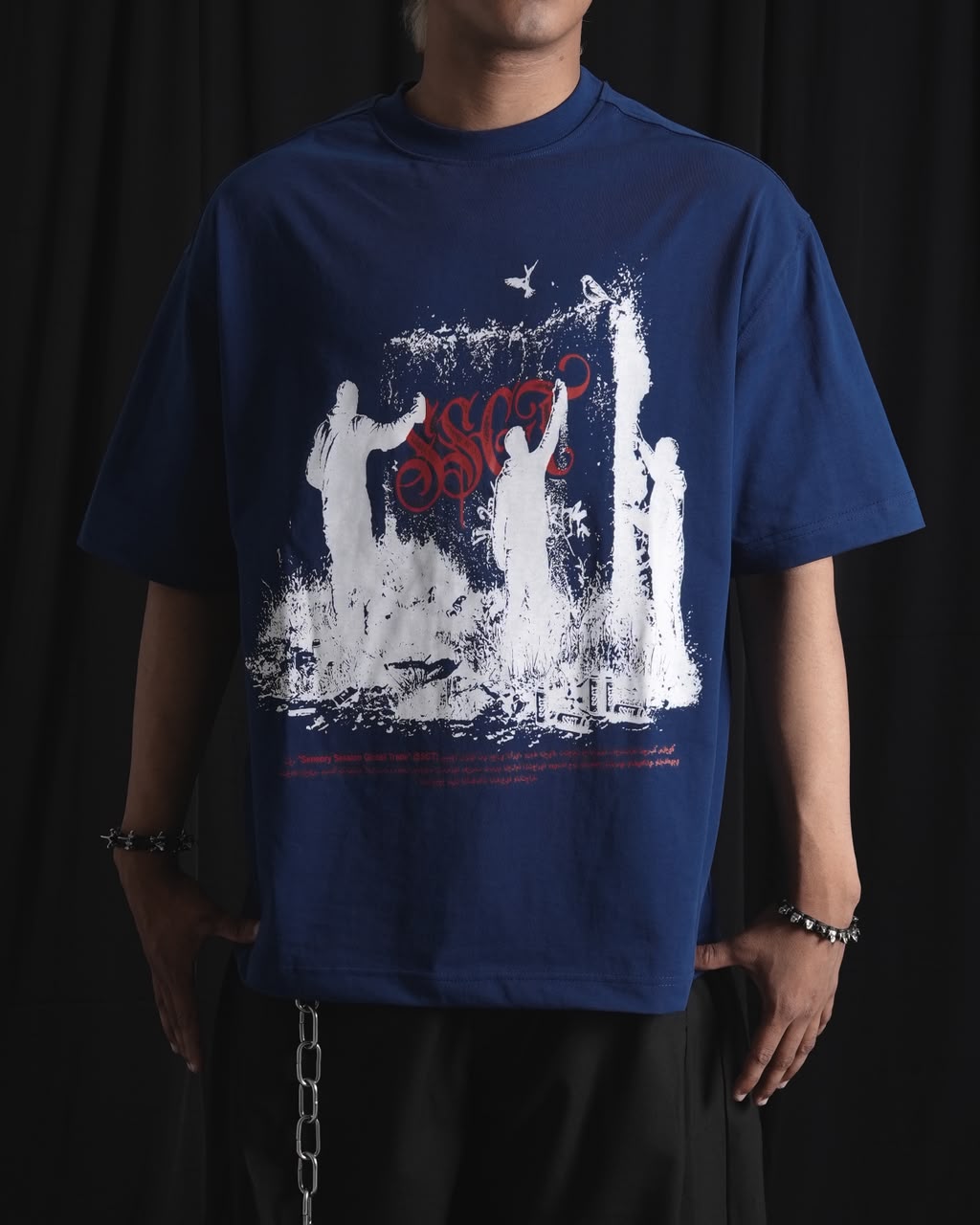 blue oversized graphic T-shirt with bold white and red urban graffiti print styled on a male model.