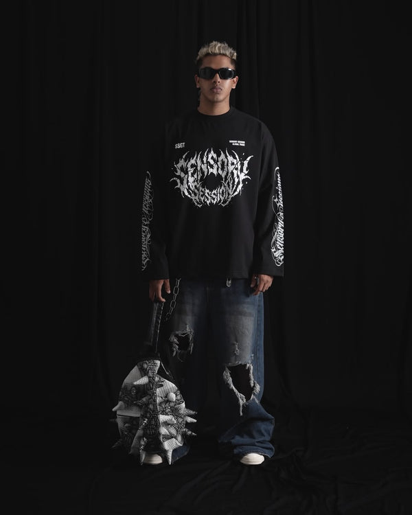 balack oversized full-sleeve graphic T-shirt with distressed white front print and sleeve designs on a male model.