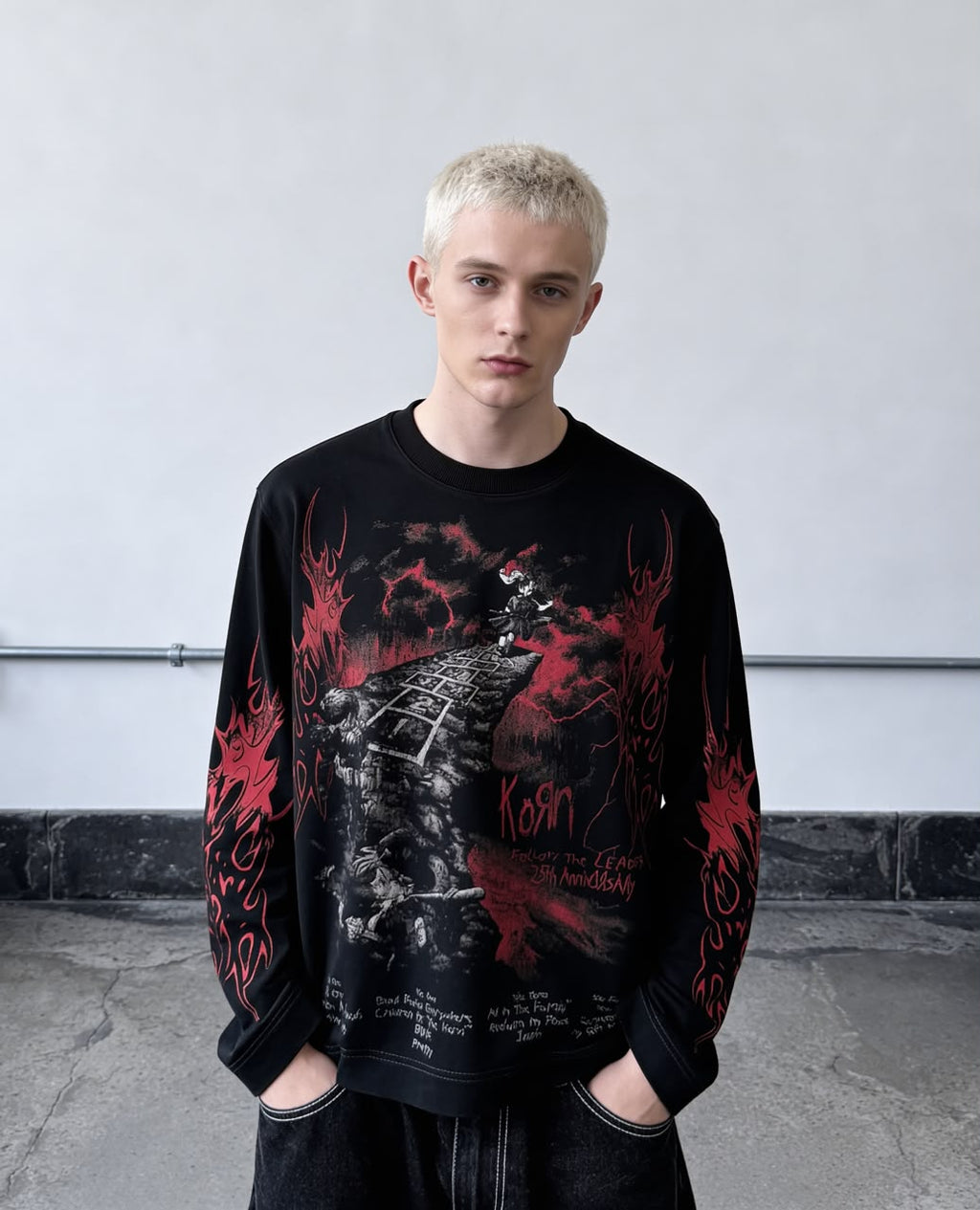 Black full-sleeve gothic graphic T-shirt with red flame print and detailed front artwork styled on a male model.