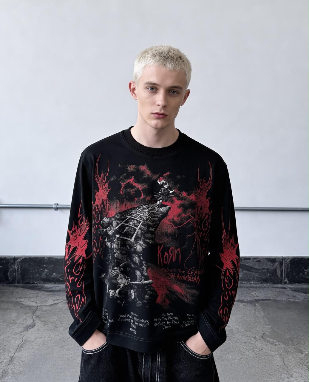 Black full-sleeve gothic graphic T-shirt with red flame print and detailed front artwork styled on a male model.