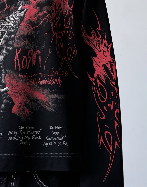 Black full-sleeve gothic graphic T-shirt with red flame print and detailed front artwork styled on a male model.
