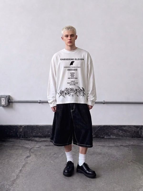 Black full-sleeve graphic T-shirt styled with baggy shorts for a modern streetwear look.